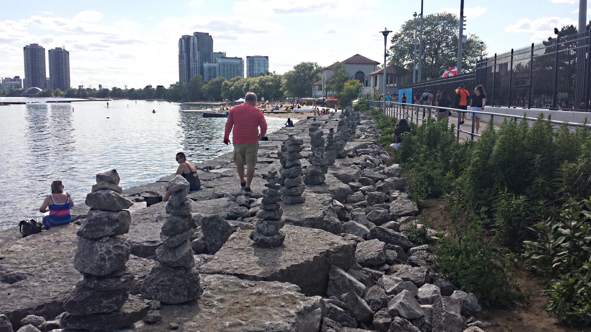 Row of rock sculptures behind Summyside pool in Toronto - evening view.